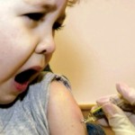 Crying baby being injected
